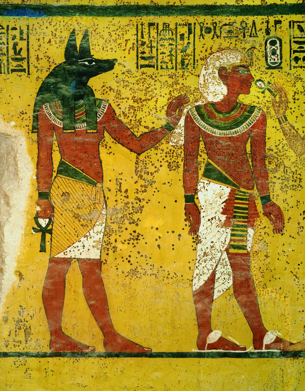 Tutankhamun and god Anubis behind him
