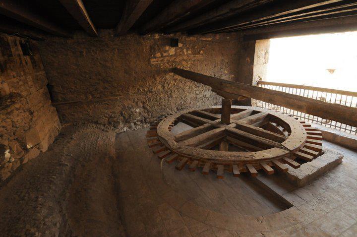 The wooden waterwheel inside the well