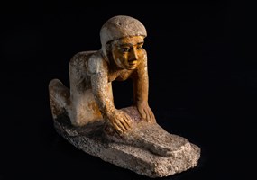 Servant statue of man grinding grain